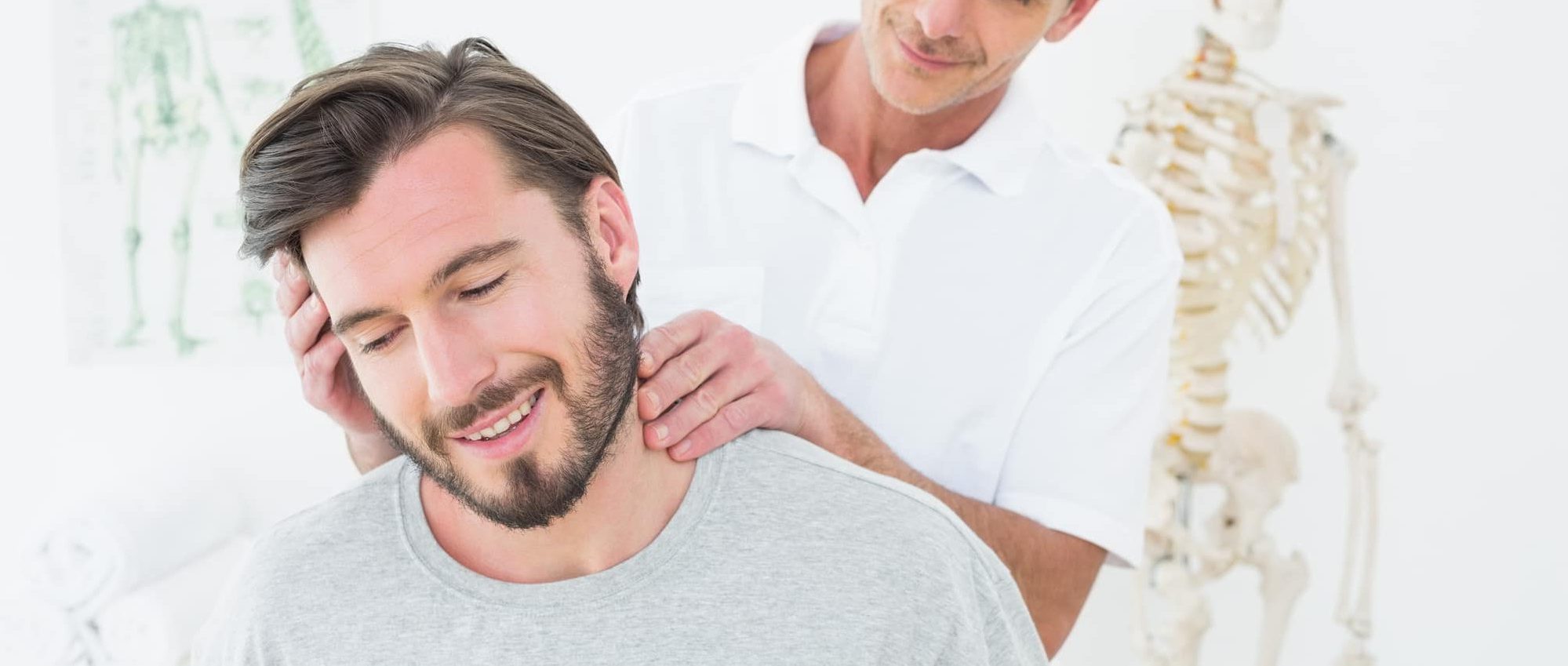 Male chiropractor doing neck adjustment in the medical office